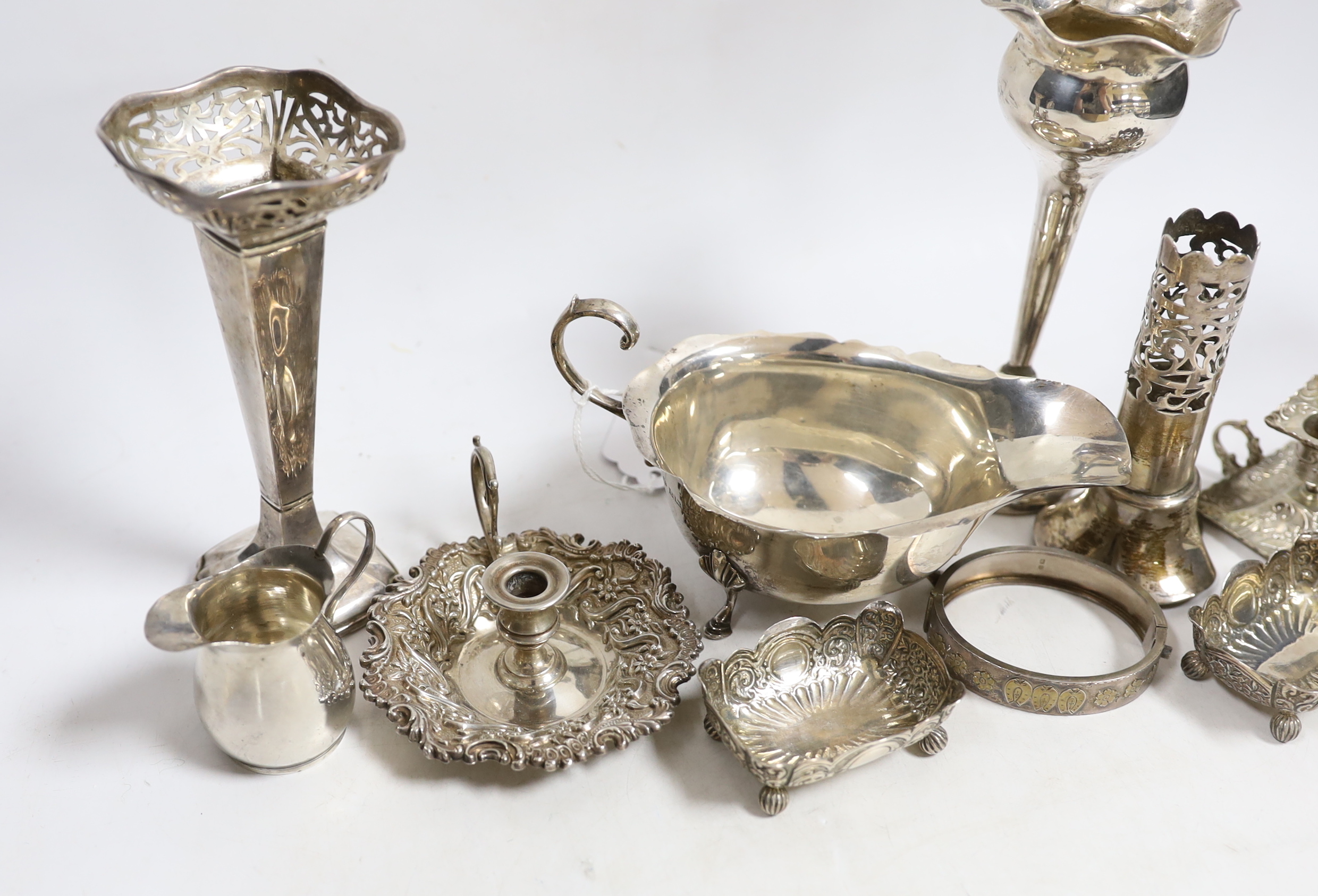Sundry small silver including a sauceboat, two mounted posy vases, pair of salts, small cream jug, mounted vase section, chamberstick and a hinged bracelet, together with a small 800 standard chamberstick.